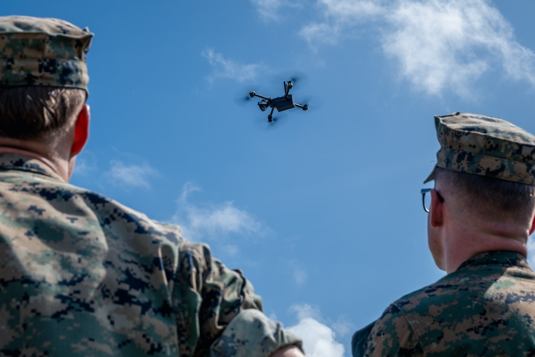 U.S. Marines with 4th Marine Regiment, 3d Marine Division observe an untethered Skydio X2D small, unmanned aircraft system fly on Camp Schwab, Okinawa, Japan, Aug. 12, 2025. This class, which certifies Marines to fly multiple variants of sUAS, was the first time untethered drones were flown over a military installation on Okinawa under the Secretary of Defense's new guidance, which seeks to expand the use of small, American-made drones to enhance military capabilities. (U.S. Marine Corps photo by Cpl. Joaquin Dela Torre)