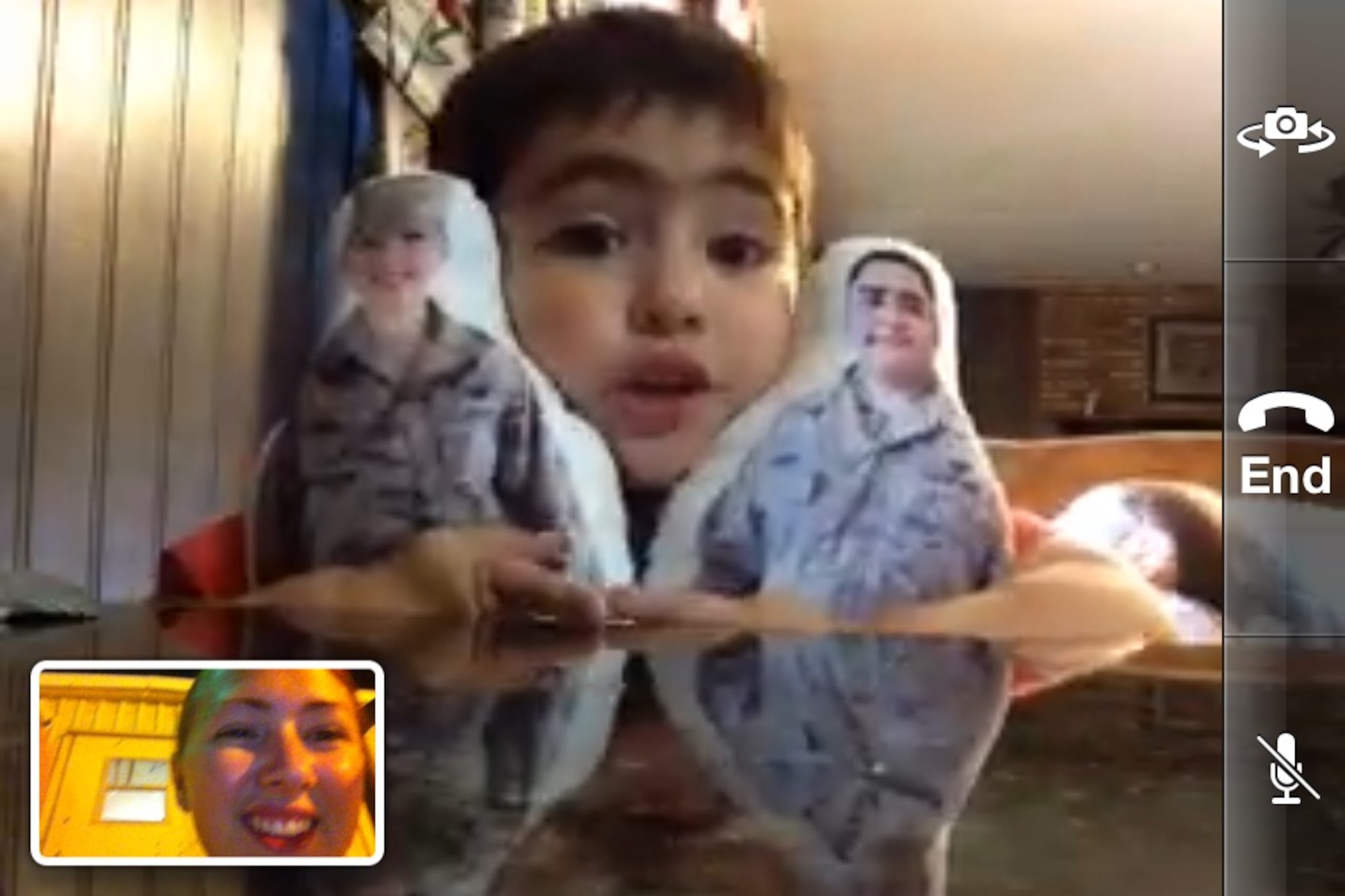 A child talks on the phone with his mother.