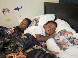Two children lay in bed.