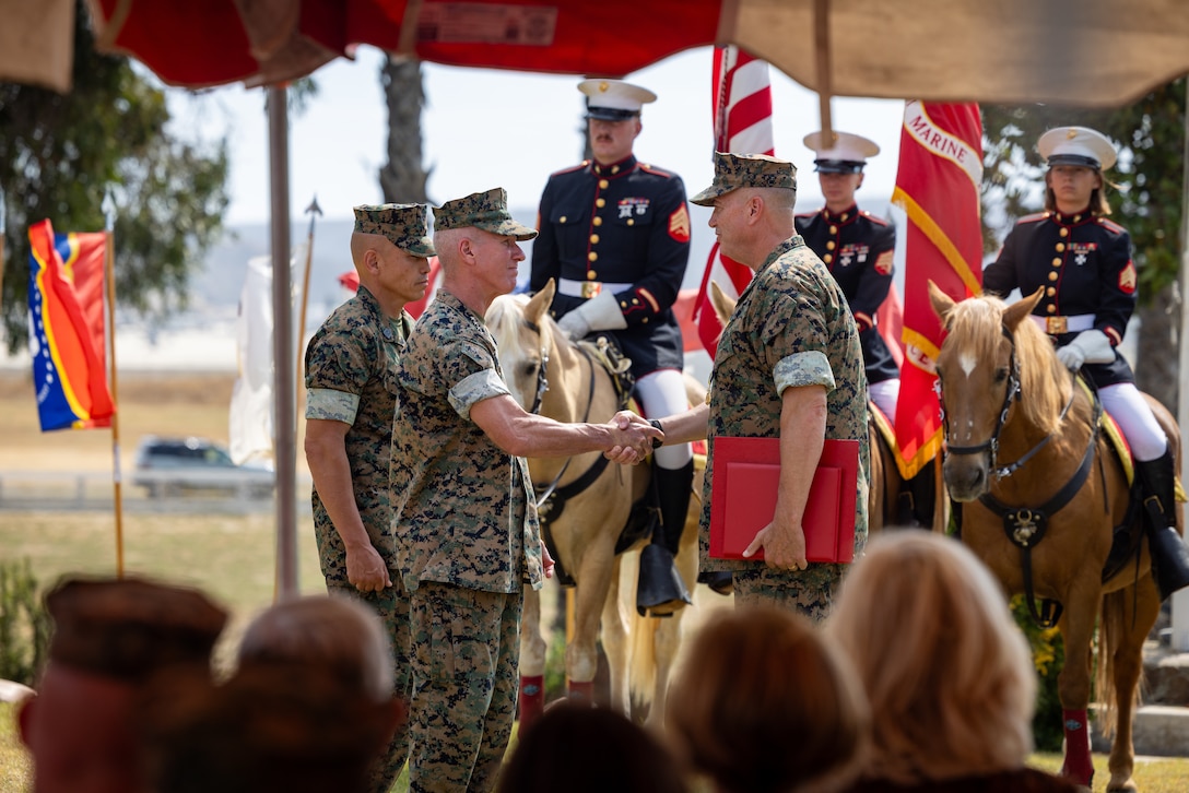 The 39th Commandant of the Marine Corps, Gen. Eric M. Smith congratulates U.S. Marine Corps Lt. Gen. Michael S. Cederholm, former commanding general of I Marine Expeditionary Force, during his retirement ceremony at Marine Corps Base Camp Pendleton, California, Aug. 21, 2025. The ceremony honored Cederholm’s 36 years of distinguished service. (U.S. Marine Corps photo by Lance Cpl. Joshua Bustamante)