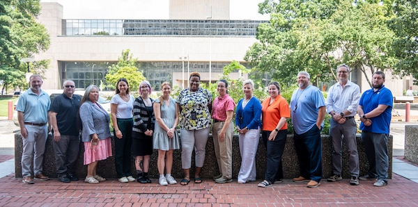 Team members of the Real Estate Division Inleasing Branch gather in front of the federal building in Downtown Louisville, Kentucky, Aug. 20, 2025.