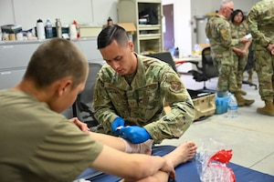 U.S. Air Force Staff Sgt. Joseph Randolph, aerospace medical specialist with the 439th Aeromedical Staging Squadron, wraps the ankle of a basic cadet at the U.S. Air Force Academy’s Jacks Valley medical clinic in Colorado Springs, CO, July 14, 2025. Basic cadet training is a six-week program designed to transition civilians into cadets ready for the four-year officer commissioning program. (U.S. Air Force photo by Staff Sgt. Stephen Underwood)