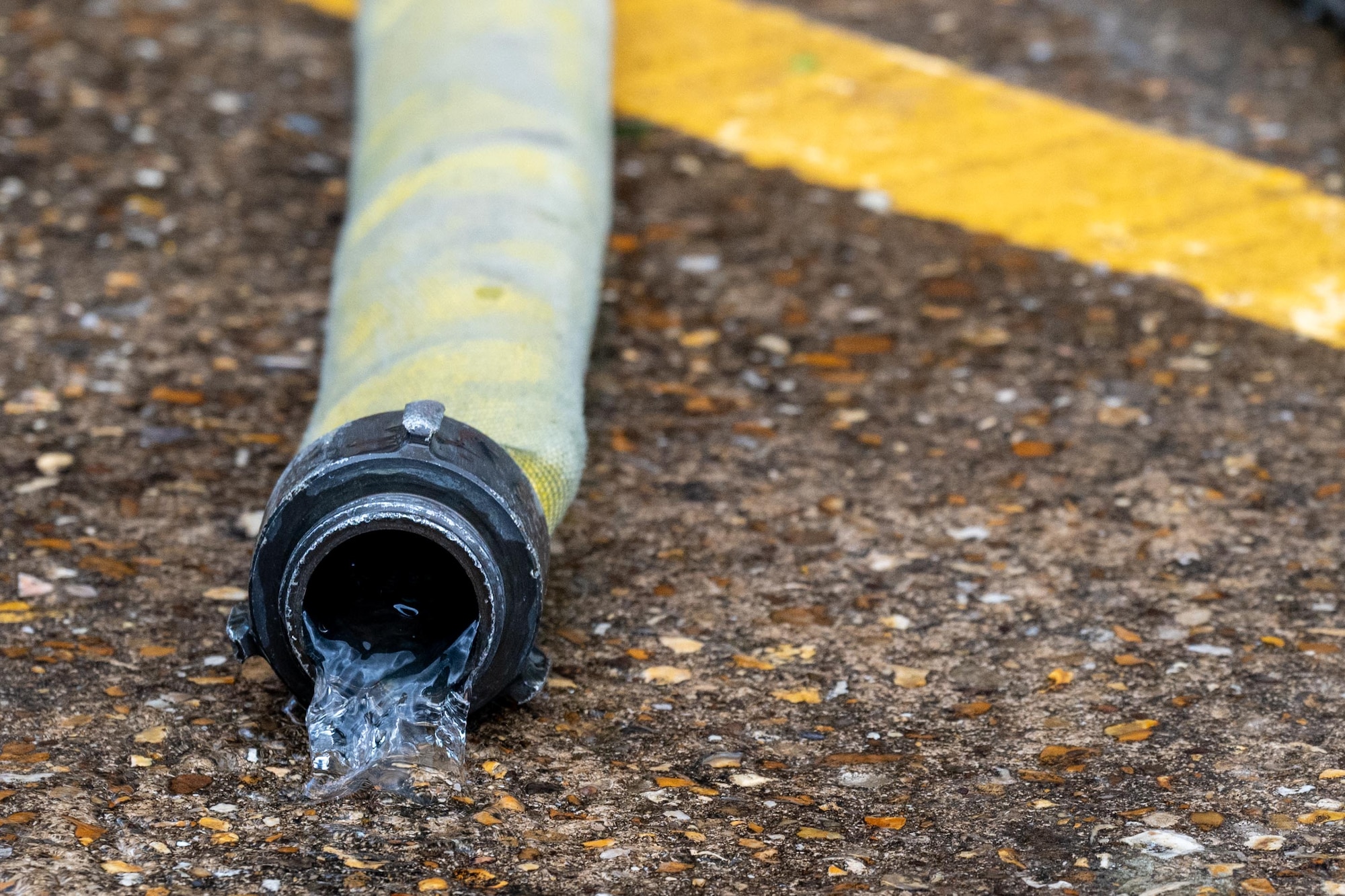 Water drains from a fire hose