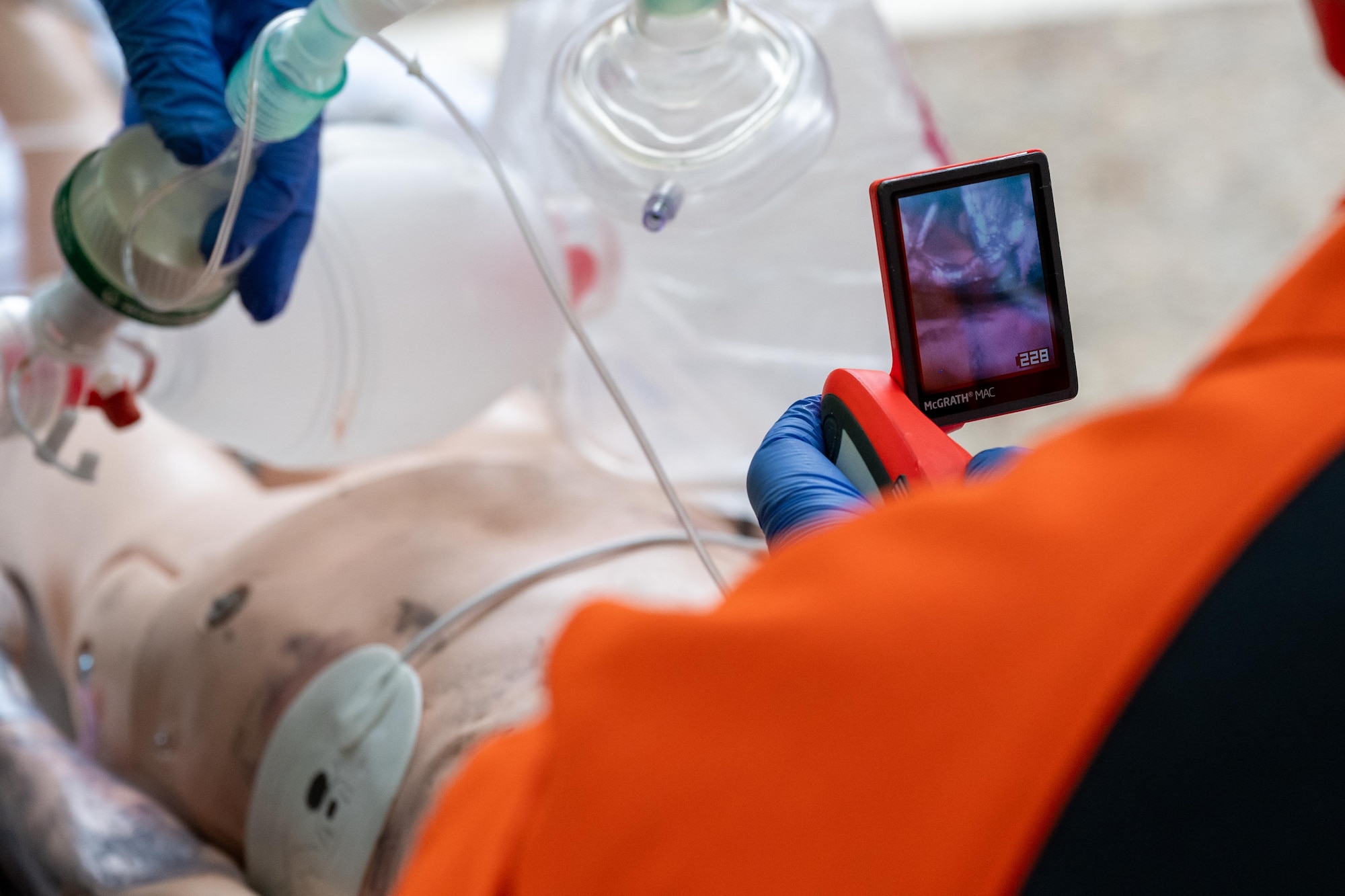A UK doctor uses a video laryngoscope while treating a training mannequin