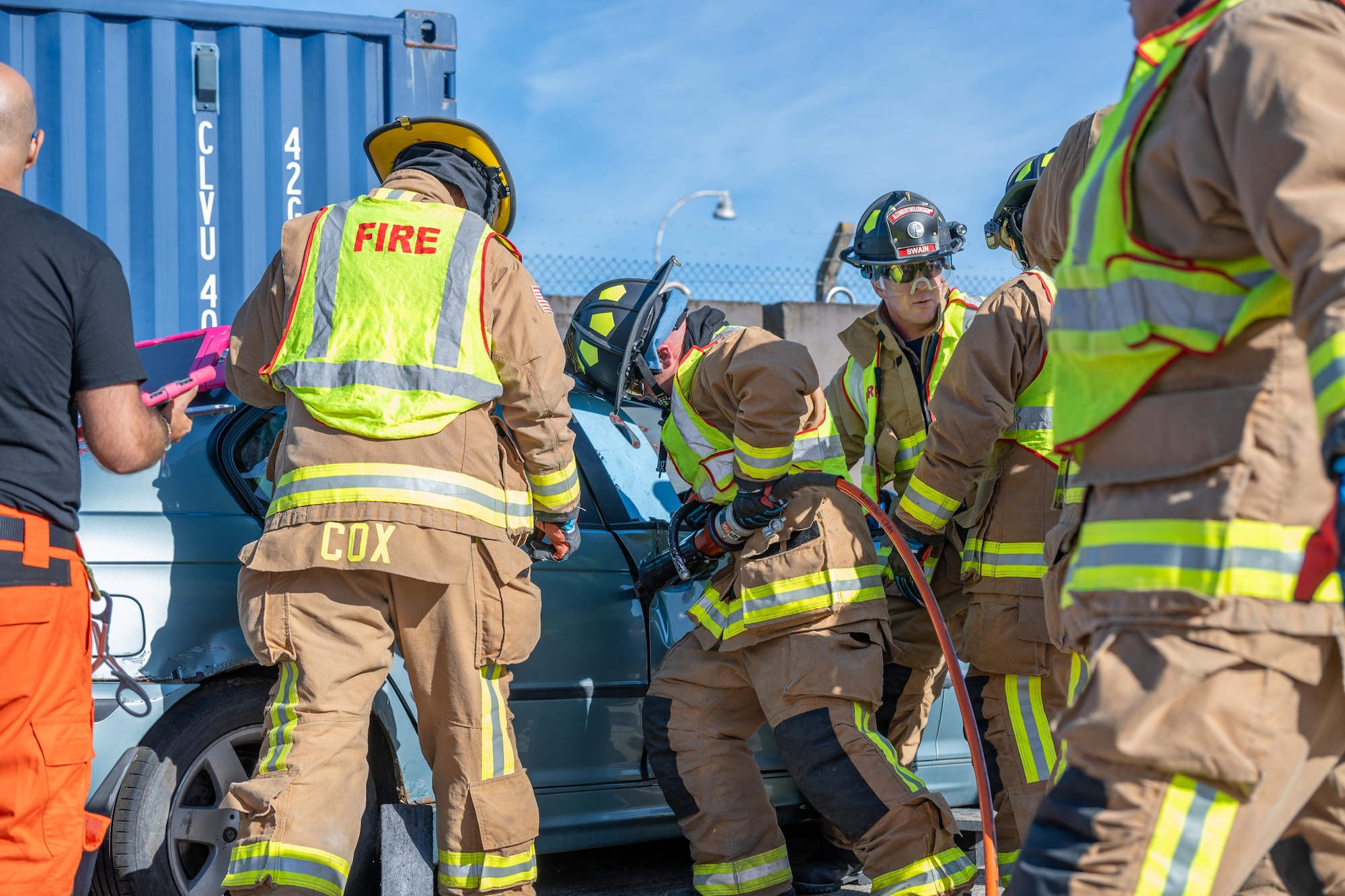 Firefighters use hydraulic rescue tools during a joint training exercise