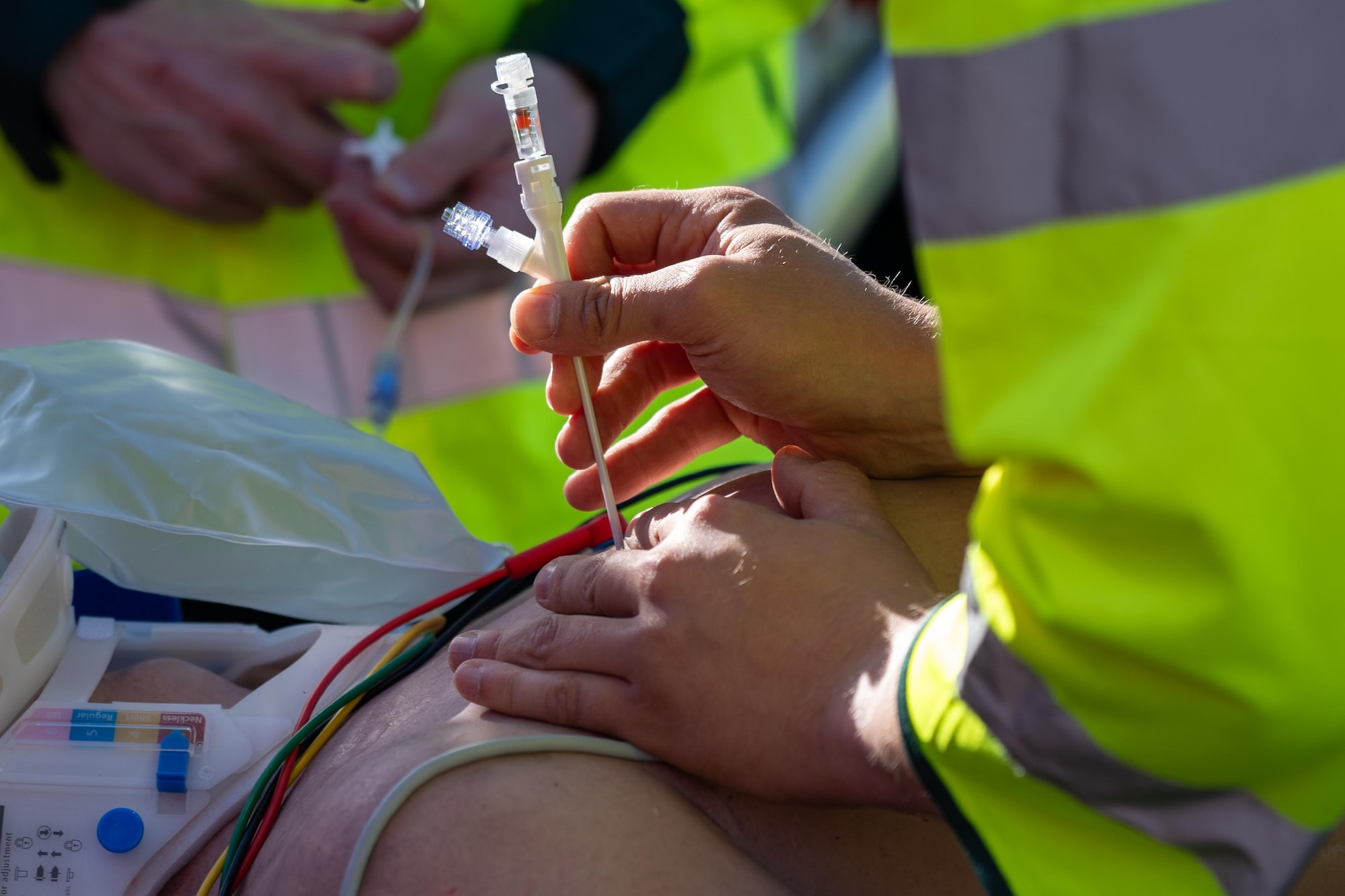 A UK paramedic performs a simulated medical procedure during a joint training exercise