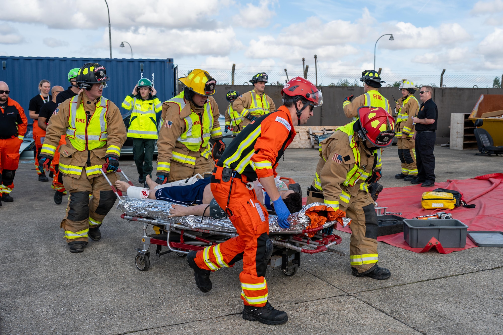 Firefighters and paramedics transport a simulated casualty