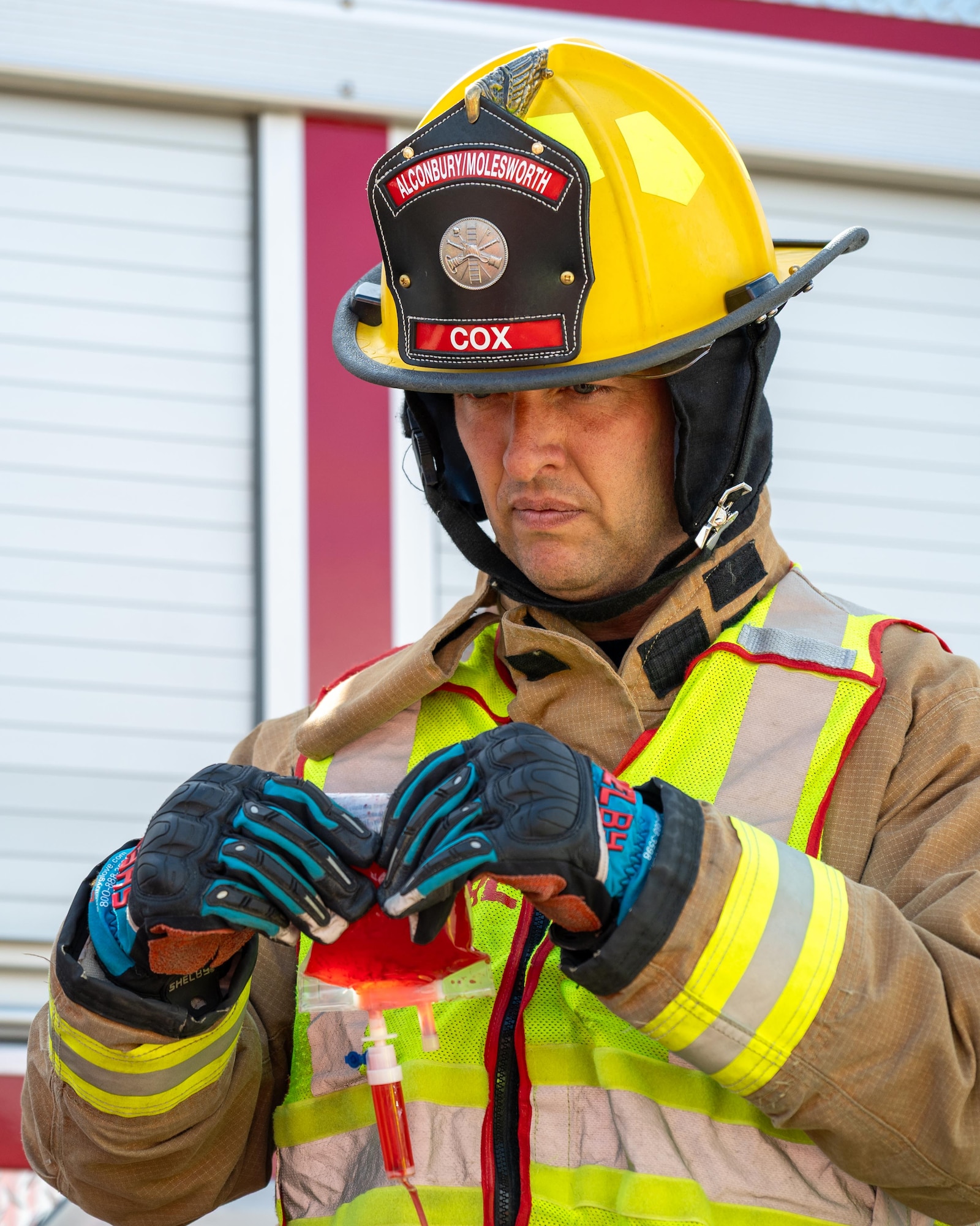 A firefighter  elevates simulated medical supplies