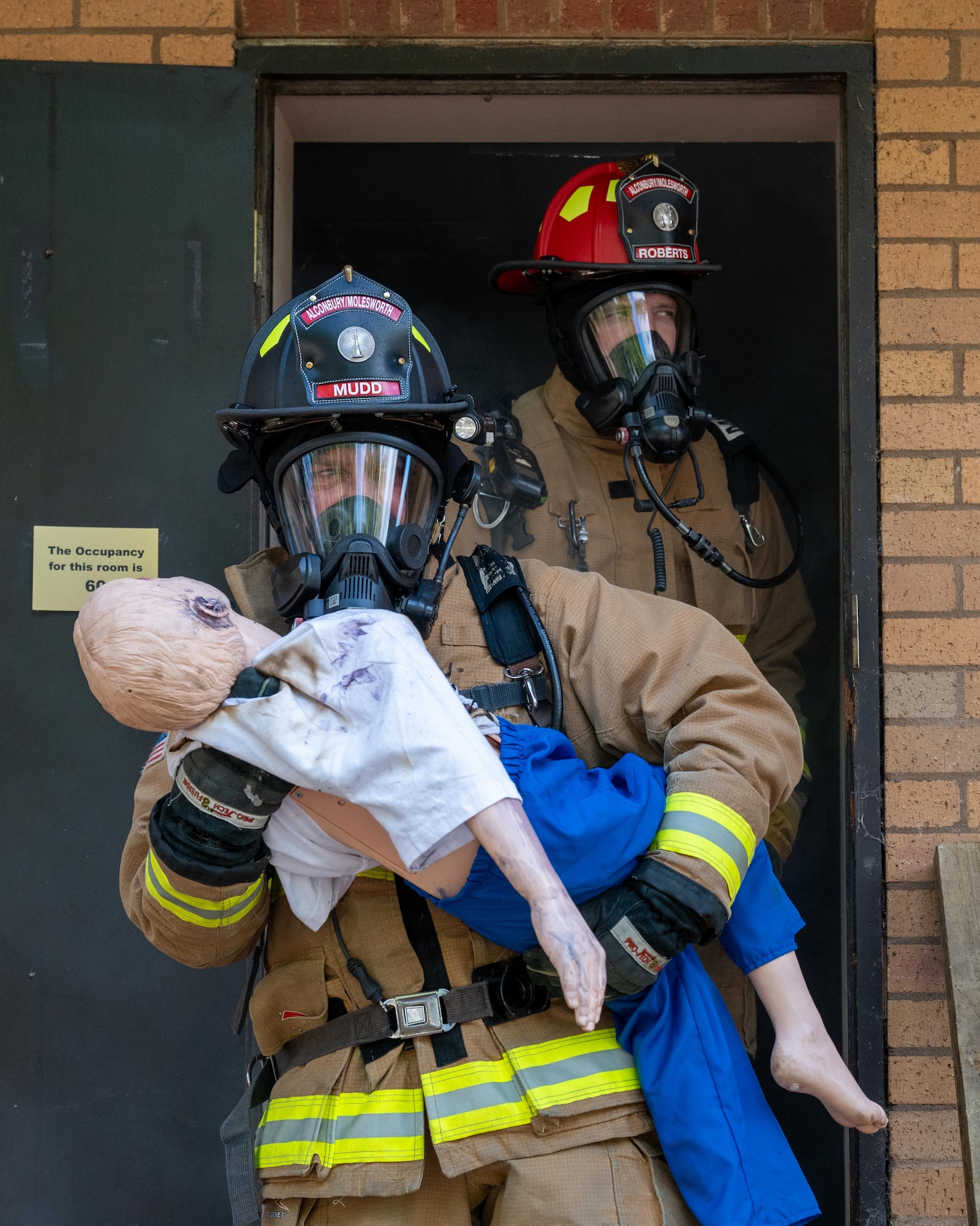 Firefighters evacuate a simulated casualty