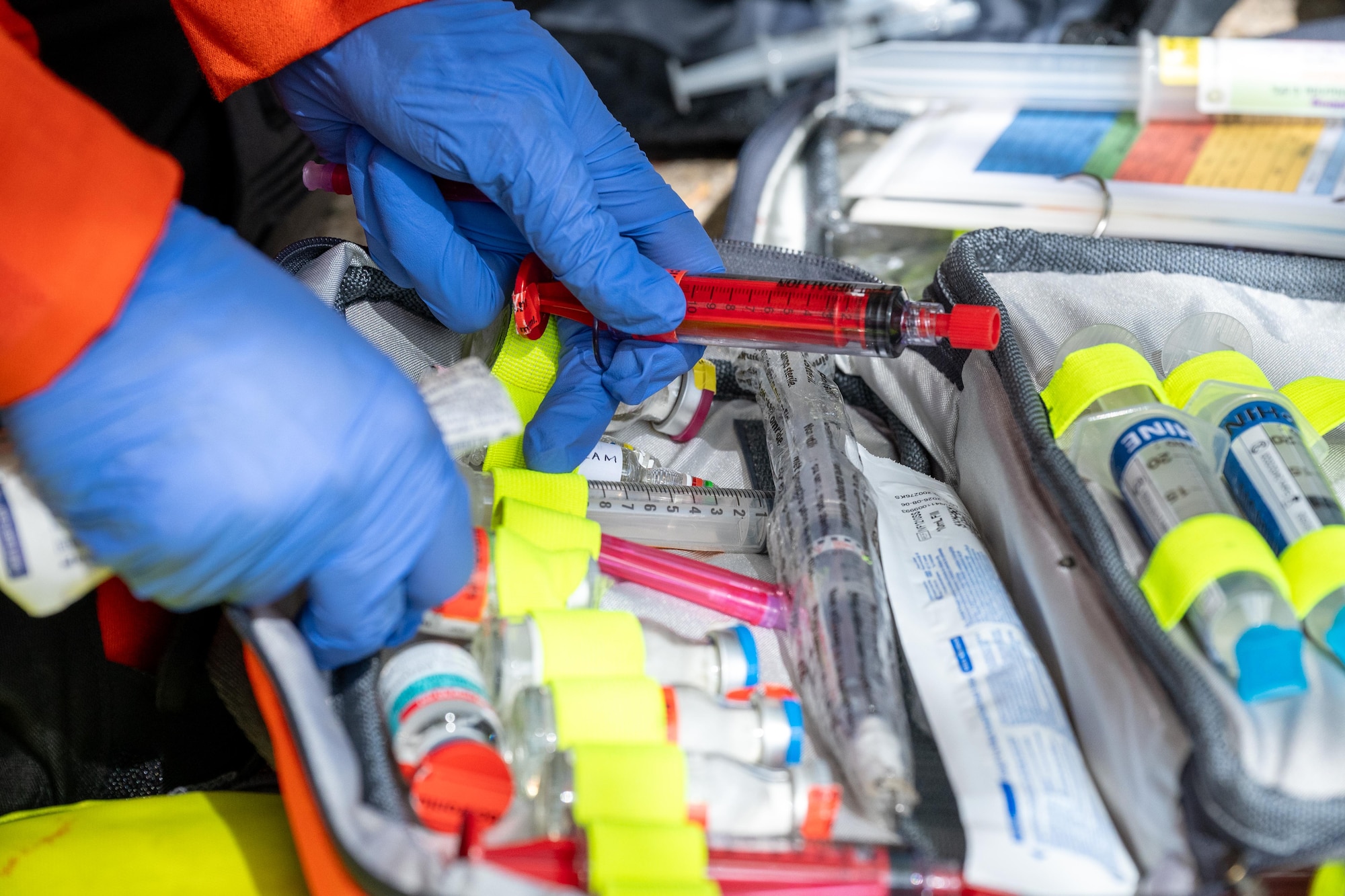 A UK paramedic organizes syringes and medical supplies