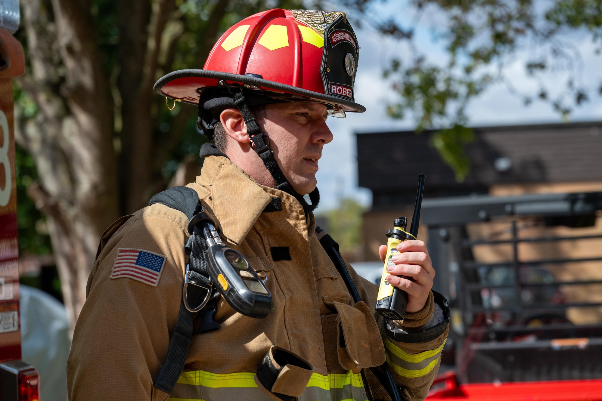A firefighter uses a radio during a joint emergency response training exercise