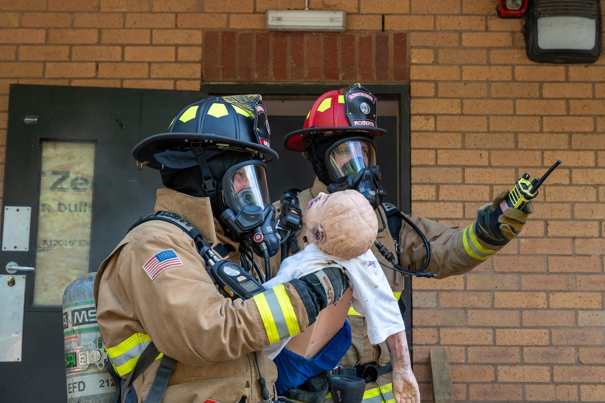 Firefighters conduct a simulated casualty rescue during a training scenario
