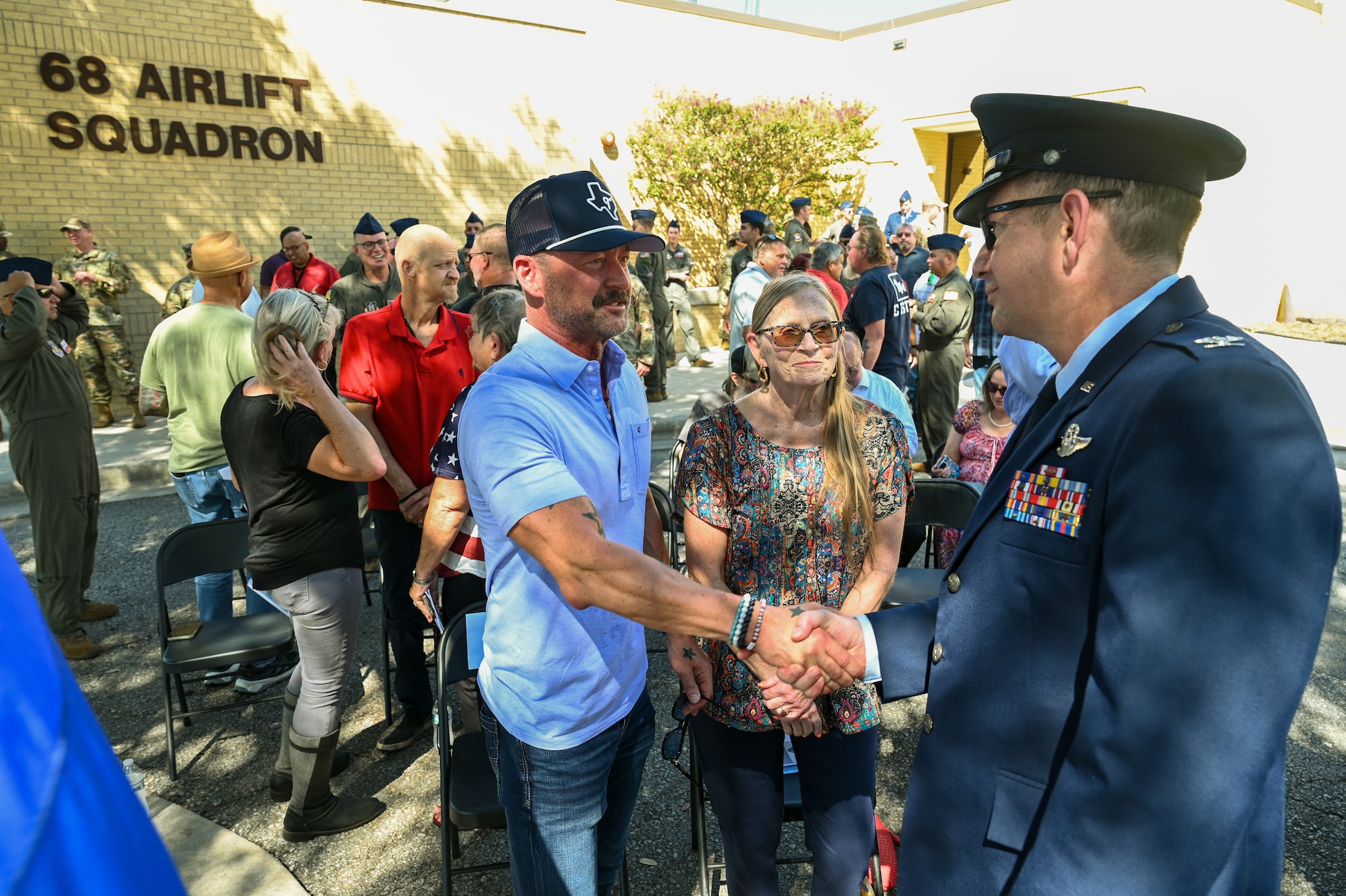 Col. Douglas Jeffrey, 433rd Airlift Wing commander, shakes hands with Anthony Price following a remembrance ceremony outside the 68th Airlift Squadron building on Joint Base San Antonio-Lackland, Texas Aug. 29, 2025.