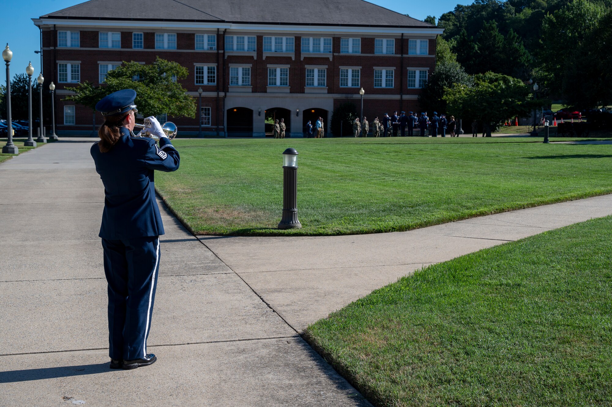 U.S. Air Force Master Sgt. Kristin J. Cazenave, a trumpeter with The U.S. Air Force Band’s Ceremonial Brass, plays taps during a funeral demonstration to attendees of an immersion tour at Joint Base Anacostia-Bolling, Washington, D.C., Aug. 26, 2025. The tour gave new JBAB and Air Force District of Washington leadership firsthand insight on the operations of the Ceremonial Brass which is to provide musical support for funerals at Arlington National Cemetery, foreign heads of state at the White House and Pentagon, patriotic programs, change of commands, and retirement and award ceremonies. (U.S. Air Force photo by Hayden Hallman)