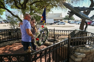 Anthony Price and his mother Susan Venuto embrace after placing a wreath at the BRAVO-12 memorial as part of a remembrance ceremony outside the 68th Airlift Squadron building on Joint Base San Antonio-Lackland, Texas Aug. 29, 2025.