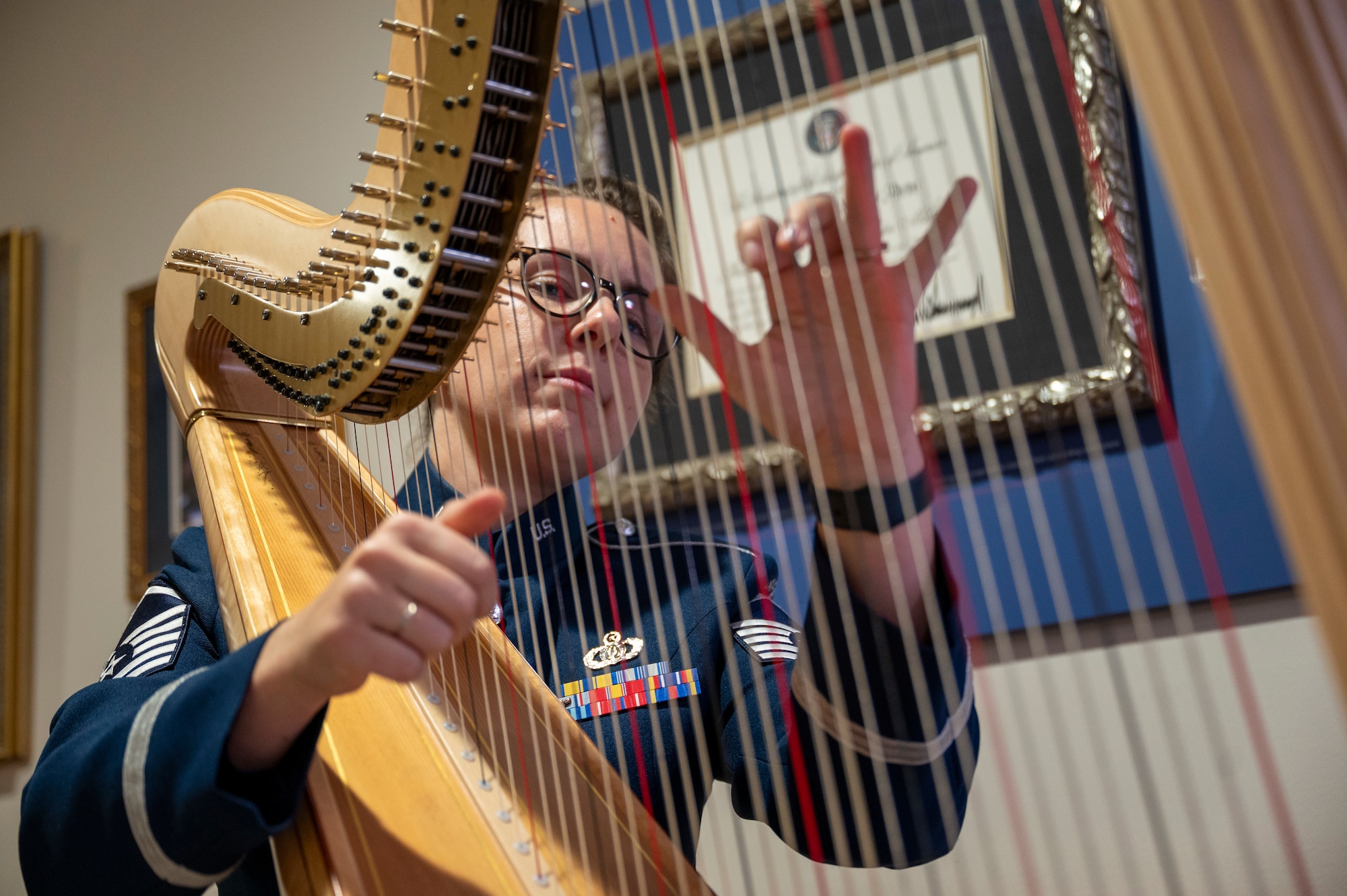 U.S. Air Force Master Sgt. Gréta K. Ásgeirsson, principal harpist with The U.S. Air Force Band’s Concert Band, performs during an immersion tour at Joint Base Anacostia-Bolling, Washington, D.C., Aug. 26, 2025. The tour gave new JBAB and Air Force District of Washington leadership firsthand insight on the operations of the Concert Band which performs across the United States via biannual tours, engages the local community in our nation's capital through numerous concert series, and reaches millions globally through live radio, television and internet broadcasts. (U.S. Air Force photo by Hayden Hallman)