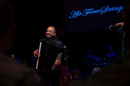 U.S. Air Force Senior Master Sgt. Frank J. Busso Jr., the accordionist with the U.S. Air Force Band’s Air Force Strings, performs for attendees of an immersion tour at Joint Base Anacostia-Bolling, Washington, D.C., Aug. 26, 2025. The tour gave new JBAB and Air Force District of Washington leadership firsthand insight on the operations of the Air Force Strings which appear regularly at military and civilian ceremonial functions, education outreach events, and concerts in the metropolitan Washington, D.C. area. (U.S. Air Force photo by Hayden Hallman)