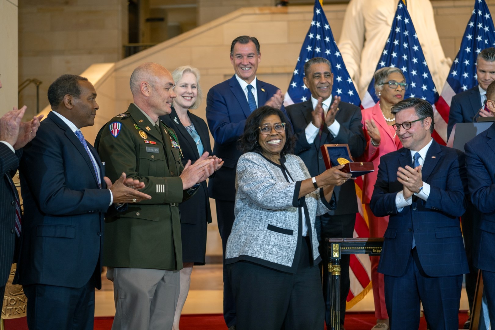 Debra Willett, center, displays the Congressional Gold Medal for the Army’s World War I 369th Infantry Regiment, the “Harlem Hellfighters,” during a ceremony in Emancipation Hall at the U.S. Capitol, September 3, 2025, in Washington.