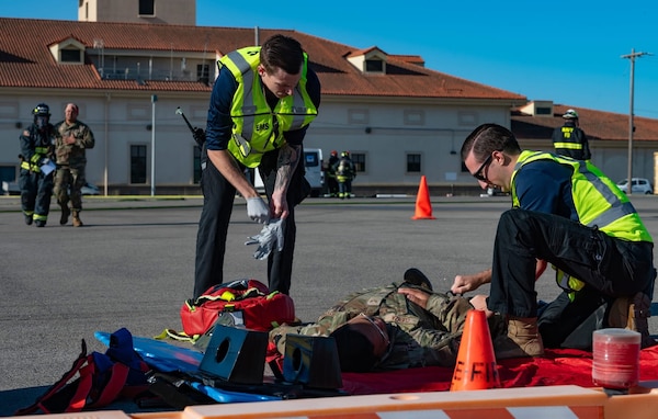 250821-N-FT324-6202. ROTA, SPAIN (Aug. 21, 2025) Hospital Corpsman Third Class John Manikas and Zachary Gould, both Emergency Medical Technicians assigned to the Emergency Department at Naval Medical Readiness and Training Command (NMRTC) Rota, triage a simulated casualty on the flight line during a joint mass casualty drill. The exercise enhanced warfighter readiness by ensuring medical personnel remain prepared to respond rapidly in operational settings. (U.S. Navy photo by Communication Specialist 1st Class Drace Wilson)