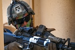A U.S. Marine chemical, biological, radiological, and nuclear (CBRN) defense specialist with 174th Marine Wing Support Squadron clears a building with an M-16 A4 Service Rifle during exercise Toxic Swell 25 at Marine Corps Training Area Bellows, Hawaii, Aug. 21, 2025. Airmen, Marines and partnered nations completed exercise Toxic Swell 25 as a joint chemical, biological, radiological, and nuclear [CBRN] response hosted by the 174 Marine Wing Support Squadron.