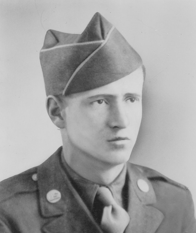 A man wearing a military uniform poses for a photo.