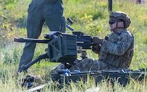 A defender Airman fires a Mk 19 automatic grenade launcher.