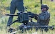 A defender Airman fires a Mk 19 automatic grenade launcher.