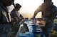 Defender Airmen load simulation rounds into magazines.