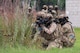 Defender Airmen post with weapons ready during a field training exercise.