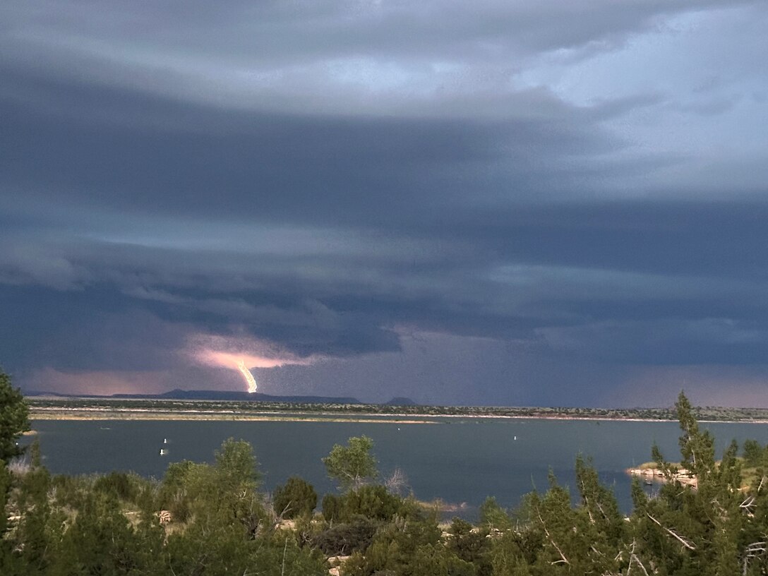 Lightning strikes Alligator Mountain during a storm, Aug. 1, 2025. Santa Rosa Lake, N.M., is seen in the foreground. Photo by Paul Sanchez.