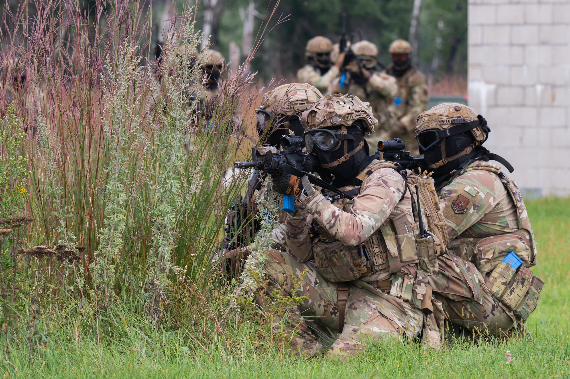 Defender Airmen post with weapons ready during a field training exercise.