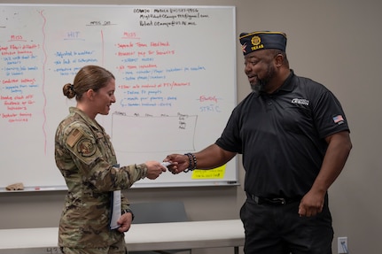 Staff Sgt. Lindsey Neubauer, 433rd Aeromedical Staging Squadron, was presented with a membership to American Legion Post 300 by Ventura "Ace" Tounsel, during the 433rd Medical Group’s commander’s call, Aug. 2, 2025.