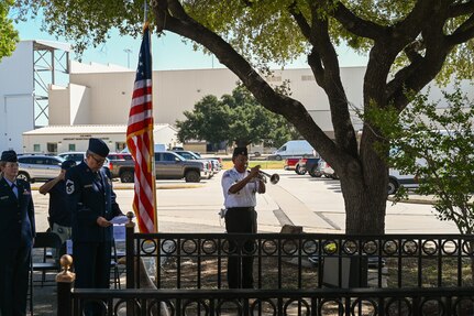 Porfirio Montellano, Fort Sam Houston Memorial Services Division bugler, plays taps during a remembrance ceremony outside the 68th Airlift Squadron building on Joint Base San Antonio-Lackland, Texas Aug. 29, 2025.