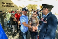 Col. Douglas Jeffrey, 433rd Airlift Wing commander, shakes hands with Anthony Price following a remembrance ceremony outside the 68th Airlift Squadron building on Joint Base San Antonio-Lackland, Texas Aug. 29, 2025.