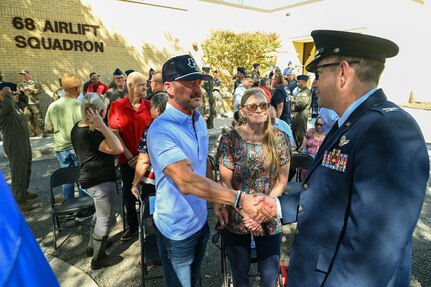 Col. Douglas Jeffrey, 433rd Airlift Wing commander, shakes hands with Anthony Price following a remembrance ceremony outside the 68th Airlift Squadron building on Joint Base San Antonio-Lackland, Texas Aug. 29, 2025.