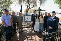 Col. Douglas Jeffrey, 433rd Airlift Wing commander, and Chaplain (Maj.) Heather Mendoza, 433rd Airlift Wing deputy chaplain, pose for a group photo with one of the survivors and family members of the BRAVO-12 crew following a remembrance ceremony outside the 68th Airlift Squadron building on Joint Base San Antonio-Lackland, Texas Aug. 29, 2025.