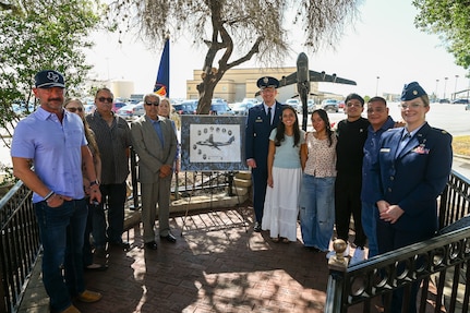 Col. Douglas Jeffrey, 433rd Airlift Wing commander, and Chaplain (Maj.) Heather Mendoza, 433rd Airlift Wing deputy chaplain, pose for a group photo with one of the survivors and family members of the BRAVO-12 crew following a remembrance ceremony outside the 68th Airlift Squadron building on Joint Base San Antonio-Lackland, Texas Aug. 29, 2025.