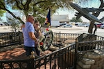 Anthony Price and his mother Susan Venuto embrace after placing a wreath at the BRAVO-12 memorial as part of a remembrance ceremony outside the 68th Airlift Squadron building on Joint Base San Antonio-Lackland, Texas Aug. 29, 2025.