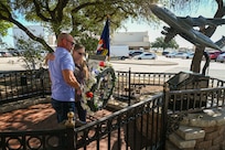 Anthony Price and his mother Susan Venuto embrace after placing a wreath at the BRAVO-12 memorial as part of a remembrance ceremony outside the 68th Airlift Squadron building on Joint Base San Antonio-Lackland, Texas Aug. 29, 2025.