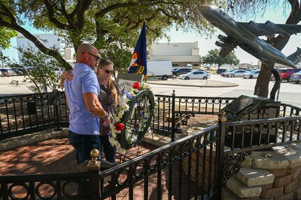 Anthony Price and his mother Susan Venuto embrace after placing a wreath at the BRAVO-12 memorial as part of a remembrance ceremony outside the 68th Airlift Squadron building on Joint Base San Antonio-Lackland, Texas Aug. 29, 2025.