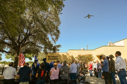 A 433rd Airlift Wing C-5M Super Galaxy passes over during a remembrance ceremony outside the 68th Airlift Squadron building on Joint Base San Antonio-Lackland, Texas Aug. 29, 2025.