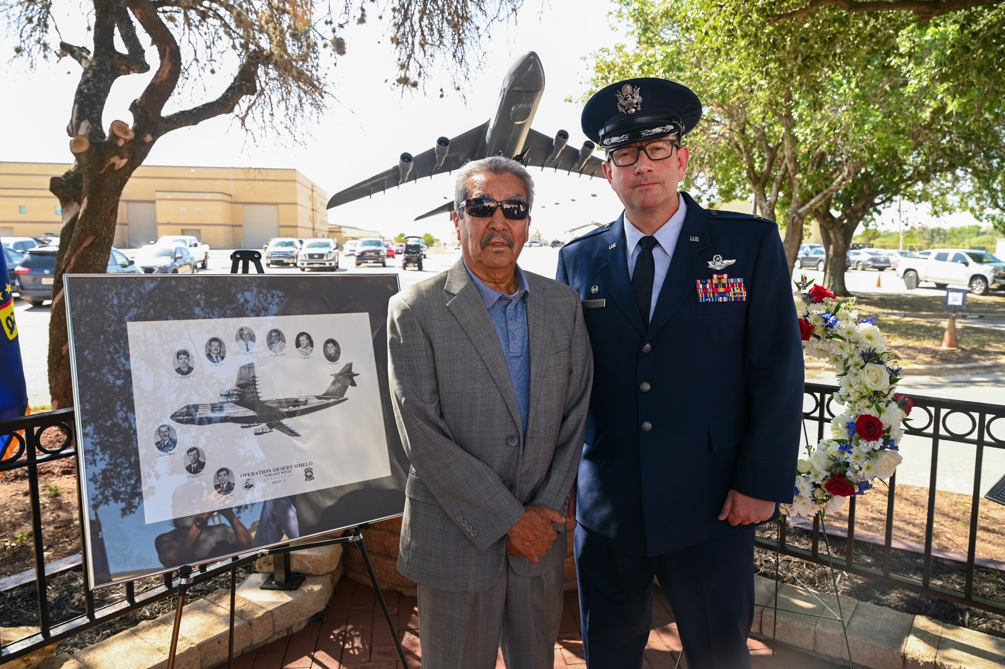 Retired Tech. Sgt. Lorenzo Galvan, a former 68th Airlift Squadron loadmaster, poses for a photo with Col. Douglas Jeffrey, 433rd Airlift Wing commander, following a remembrance ceremony outside the 68th Airlift Squadron building on Joint Base San Antonio-Lackland, Texas Aug. 29, 2025.