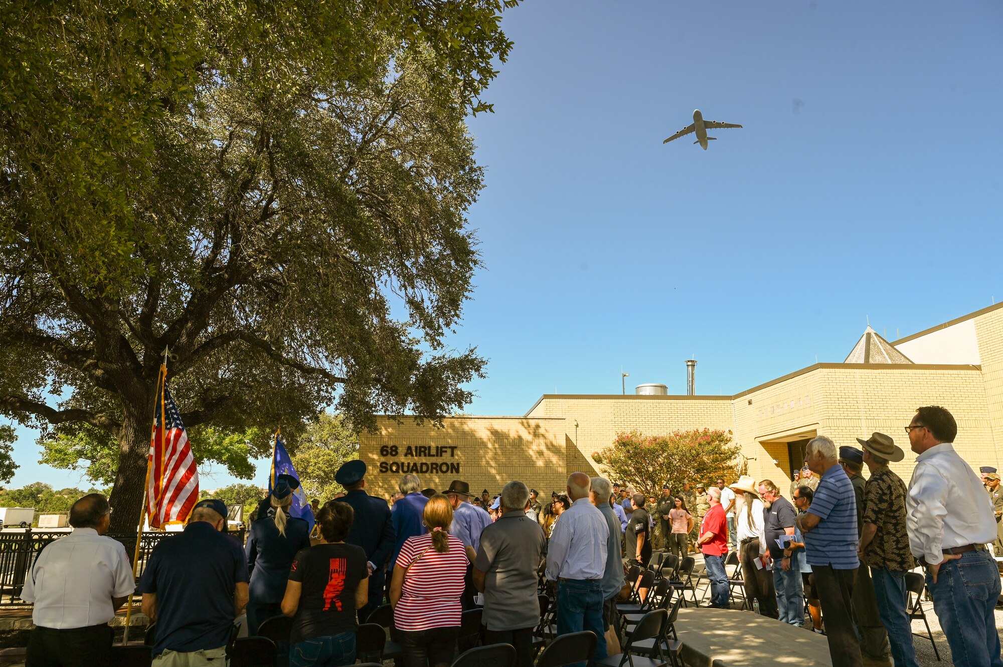 A 433rd Airlift Wing C-5M Super Galaxy passes over during a remembrance ceremony outside the 68th Airlift Squadron building on Joint Base San Antonio-Lackland, Texas Aug. 29, 2025.