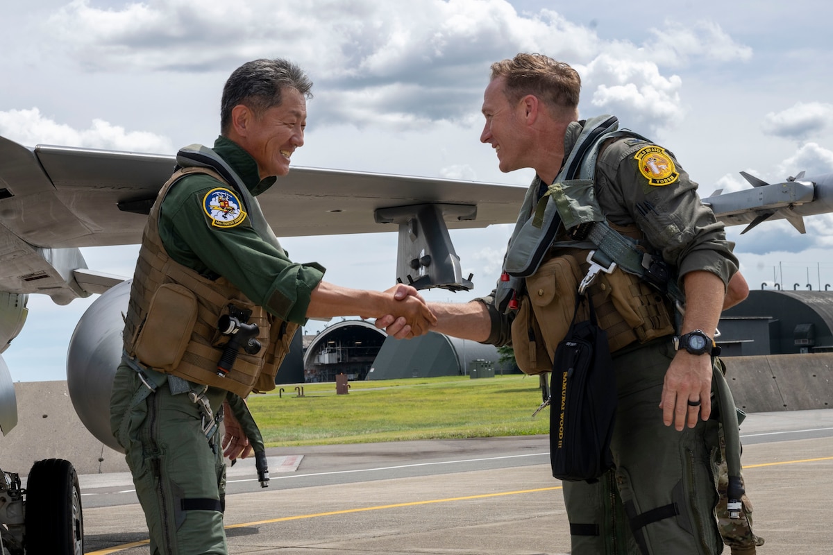 U.S. Air Force Col. Paul Davidson, right,  35th Fighter Wing (FW) commander, shakes hands with Japan Air Self-Defense Force (JASDF) Maj. Gen. Teruaki Fujita, 3rd Air Wing commander, after an orientation flight at Misawa Air Base, Japan, Aug. 28, 2025.