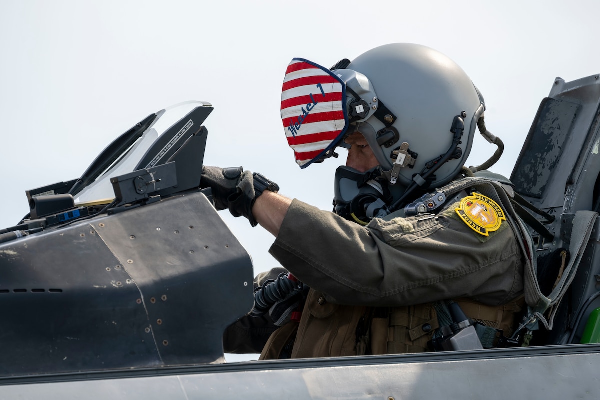 U.S. Air Force Col. Paul Davidson, 35th Fighter Wing commander, examines the cockpit of an F-16D Fighting Falcon before an orientation flight with Japan Air Self-Defense Force Maj. Gen. Teruaki Fujita, 3rd Air Wing commander, at Misawa Air Base, Japan, Aug. 28, 2025.