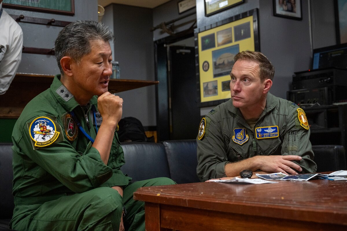 U.S. Air Force Col. Paul Davidson, right,  35th Fighter Wing commander, speaks with Japan Air Self-Defense Force Maj. Gen. Teruaki Fujita, 3rd Air Wing commander, after an orientation flight at Misawa Air Base, Japan, Aug. 28, 2025.