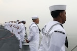 Sailors aboard the Arleigh Burke-class guided-missile destroyer USS John Finn (DDG 113) man the rails during a sea and anchor detail in Jakarta, Indonesia, Aug. 25.