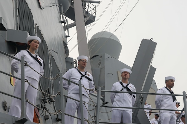 Sailors aboard the Arleigh Burke-class guided-missile destroyer USS John Finn (DDG 113) man the rails during a sea and anchor detail in Jakarta, Indonesia, Aug. 25.