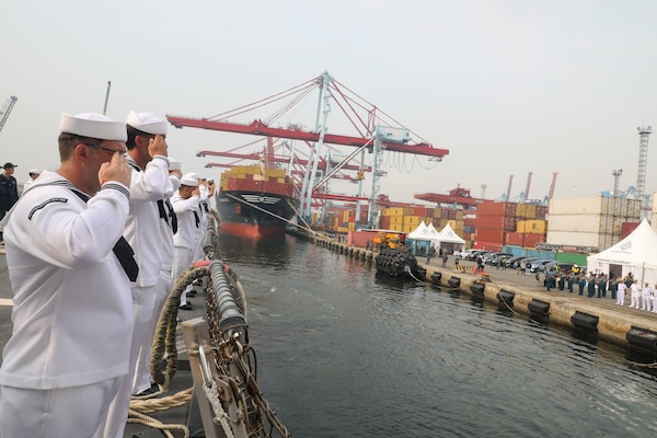 Sailors aboard the Arleigh Burke-class guided-missile destroyer USS John Finn (DDG 113) man the rails during a sea and anchor detail in Jakarta, Indonesia, Aug. 25.