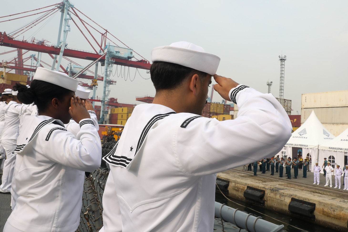 Sailors aboard the Arleigh Burke-class guided-missile destroyer USS John Finn (DDG 113) man the rails during a sea and anchor detail in Jakarta, Indonesia, Aug. 25.